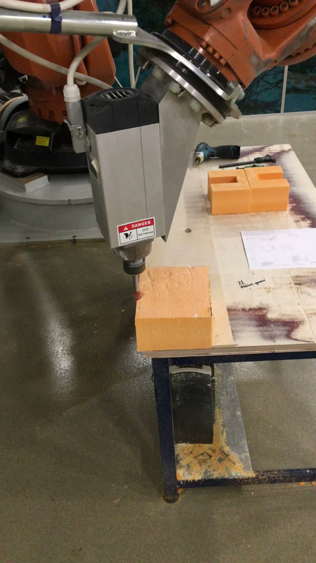 KUKA robot with self-built spindle milling a block
